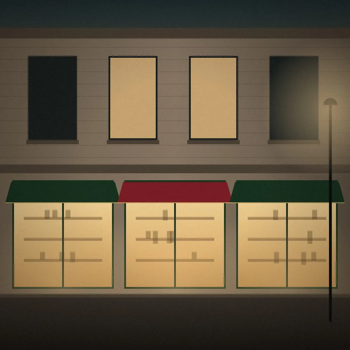 A commercial street at dusk with lit storefronts